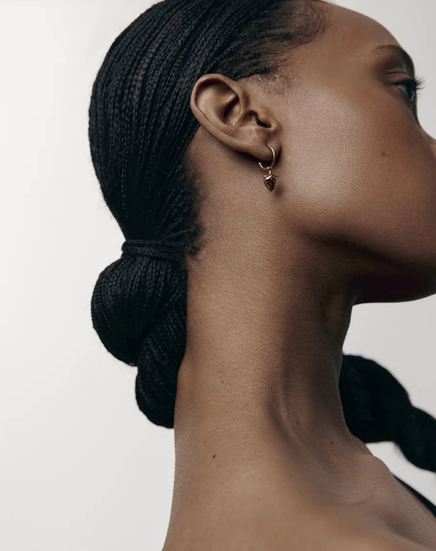 Model wearing strawberry hoop earrings
