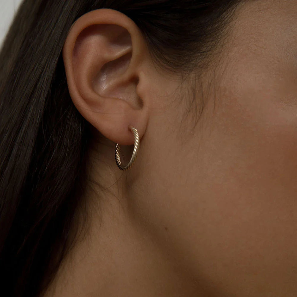 Rope hoop earrings worn by a model