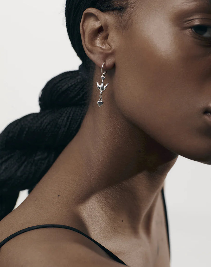 Silver hoop earrings with a bird and heart