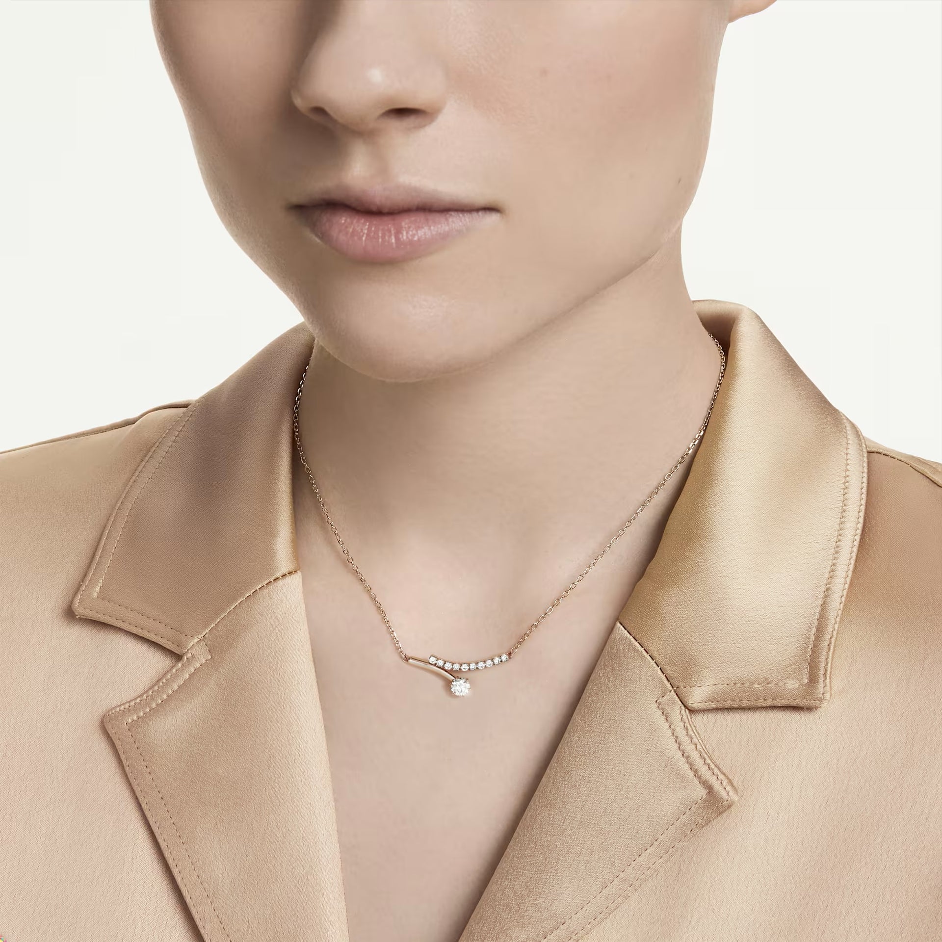 Woman wearing the Swarovski Matrix necklace in rose gold