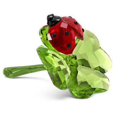 Swarovski crystal ladybug sitting on a four leaf clover