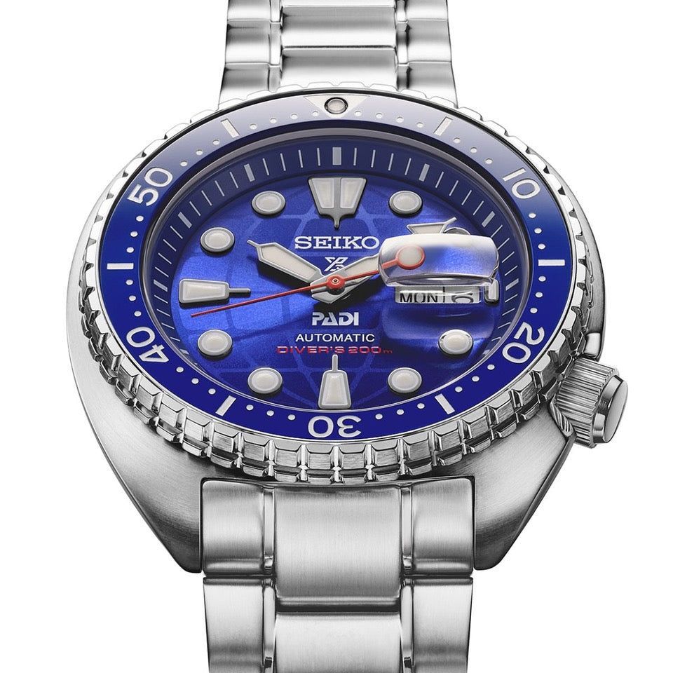 Seiko Prospex HBB002K dial close up showing blue and red PADI accents and globe motif