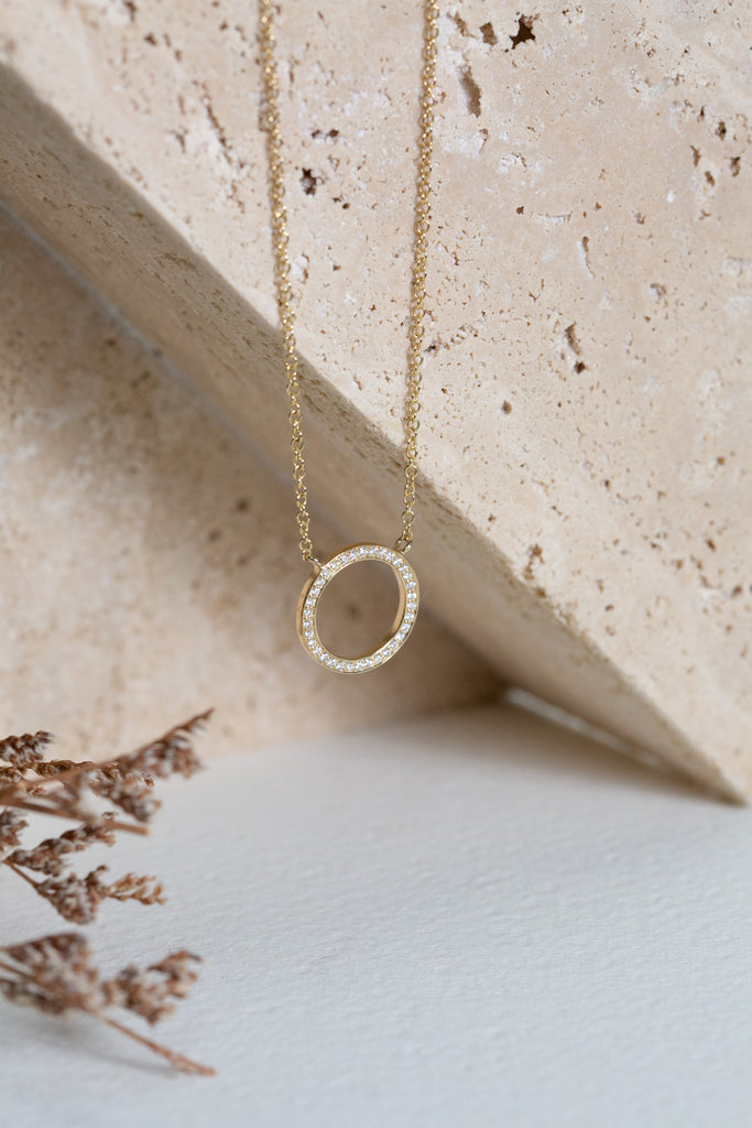 Diamond circle necklace on a gold chain